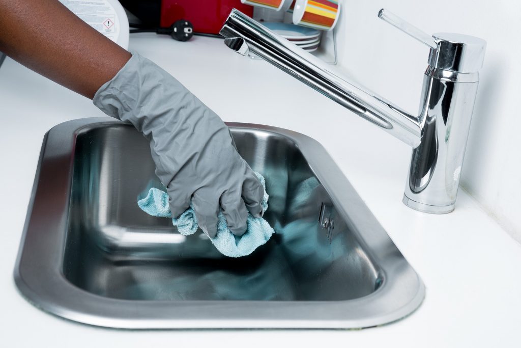 person hand cleaning sink