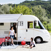 family standing outside motorhome with open awning