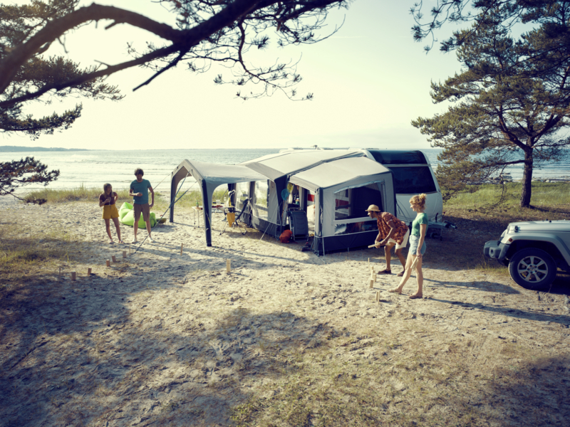 Family enjoying the weather under motorhome awning