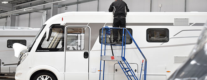 Travelworld employee servicing motorhome