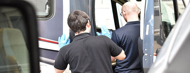 Travelworld employees servicing motorhome