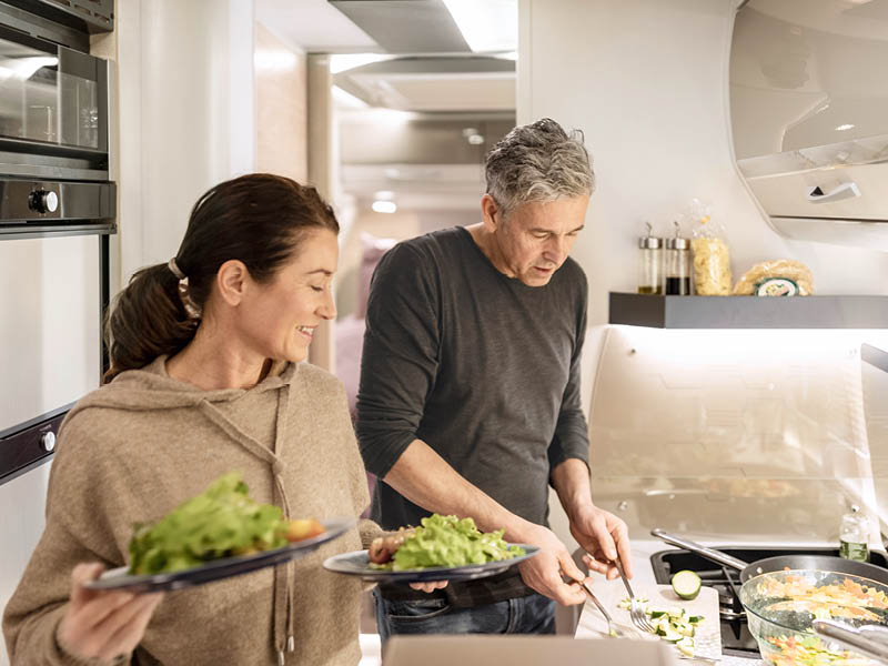 Dethleffs Trend with couple cooking inside
