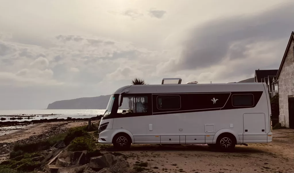 Guy's Niesmann+Bischoff iSmove motorhome next to the sea at sunset